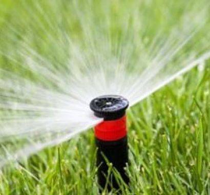 A up close view of a sprinkler head for an irrigation system spring start-up.