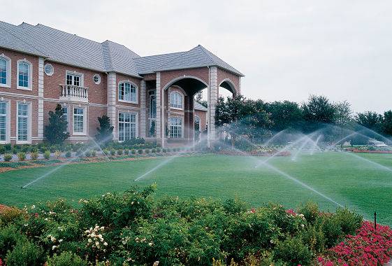 Large house with residential sprinkler system from a lawn irrigation company.