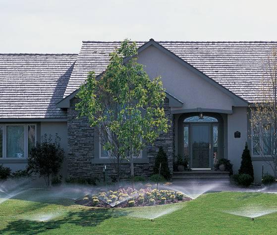 A house with in ground sprinklers from a yard irrigation company American National.