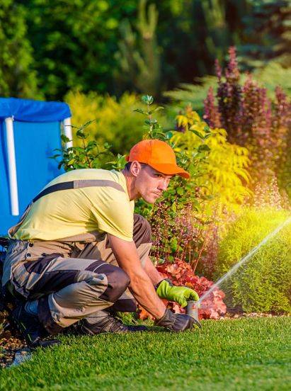 A sprinkler system technician working on sprinkler system winterization.