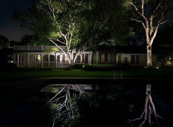 Landscape lighting on a suburban home, work done by American National Sprinkler & Lighting.