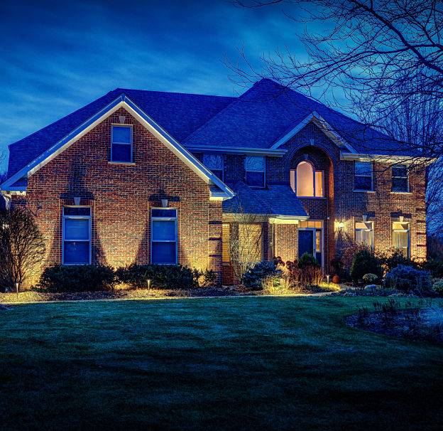 American National Sprinkler & Lighting - we provide landscape lighting for large homes - landscape lighting on a large home in Lake County, IL.